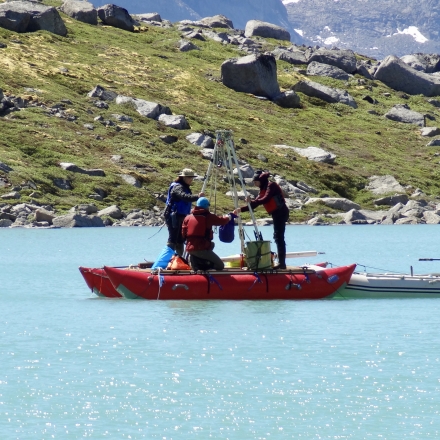 A team on a boat coring lakes in the Arctic (credit: Laura Larocca)